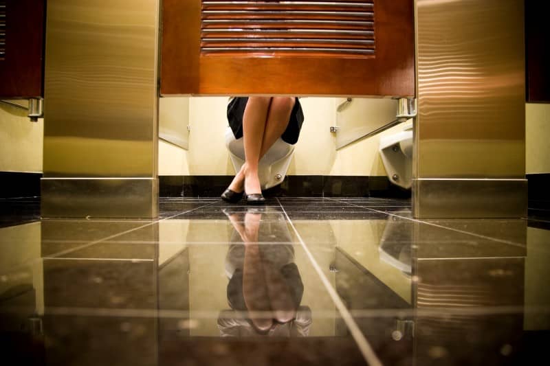 Woman's Feet Underneath Toilet Stall -cm
