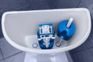 New plastic fittings in a clean toilet. Plumbing repair.-cm