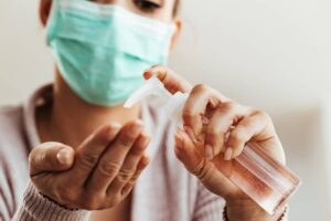 Close-up of woman cleaning her hands with antiseptic hand gel.-cm