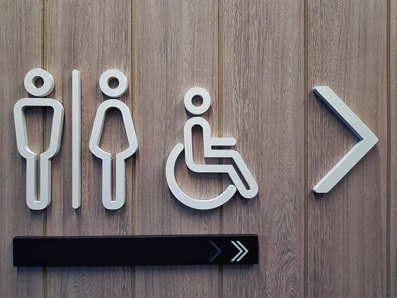 White Toilet Symbols on Wooden Plank Wall -cm
