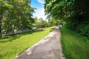 1162849473_Gravel footpath through a recreation area with picnic tables_Large-cm