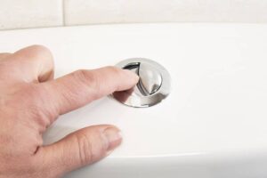 Pushing the flush button on a toilet-cm